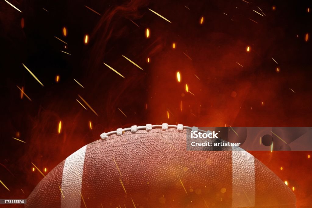 American. American football ball on black background illuminated American Football - Sport Stock Photo