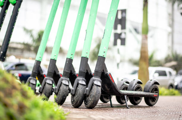 Modern eco electric city scooters for rent outdoors on the sidewalk. Alternative tourism, transportation around the city, bike replacement service. stock photo