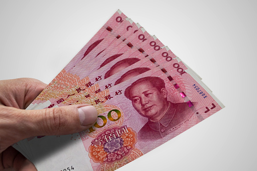 Hand holding Chinese Renminbi. RMB. Currency of China.