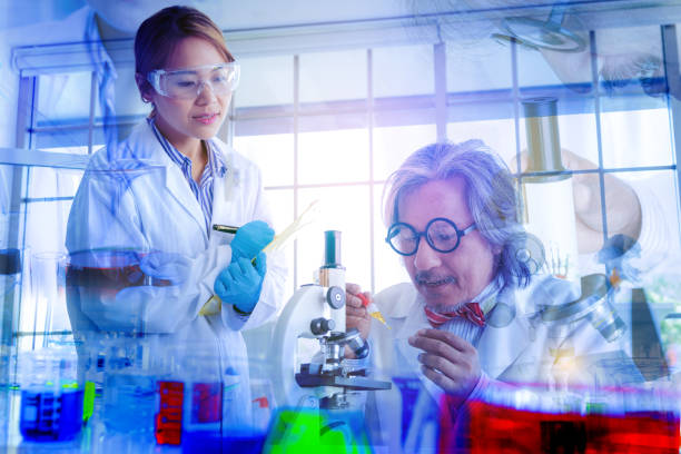 double exposure science concept background. senior scientist male supervisor research chemistry liquid with young female memory and analysis. scientist looking microscope in laboratory. - double exposure imagens e fotografias de stock