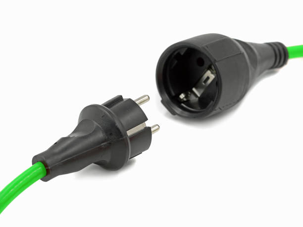 istock close up, disconnected green electrical power extension cable with EU plug, green energy 1178368216