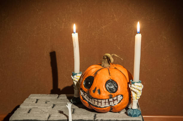 istock Halloween holiday concept. Pumpkin with a face. Burning and extinguished candles. Background for text with pumpkin and smoke. Halloween pumpkin head jack lantern with burning candles 1178368904