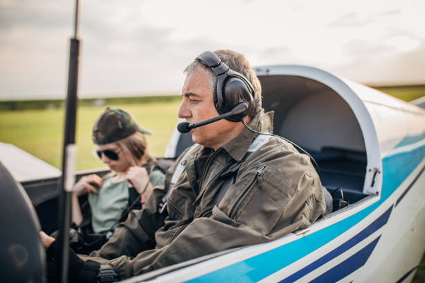 istock Daughter and father pilot sitting in airplane 1178369090
