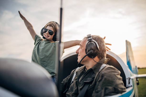 istock Daughter and father pilot sitting in airplane 1178369187