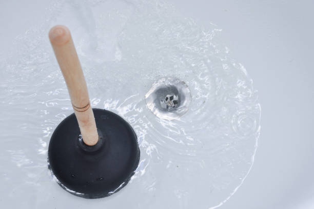 Plunger and clogged bath drain. Plunger and clogged bath drain. Cleaning concept. clogged stock pictures, royalty-free photos & images