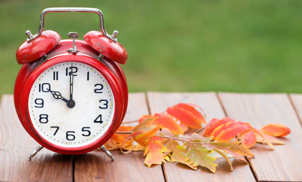 istock Daylight savings time, red alarm clock on a wooden background, web banner 1178371445