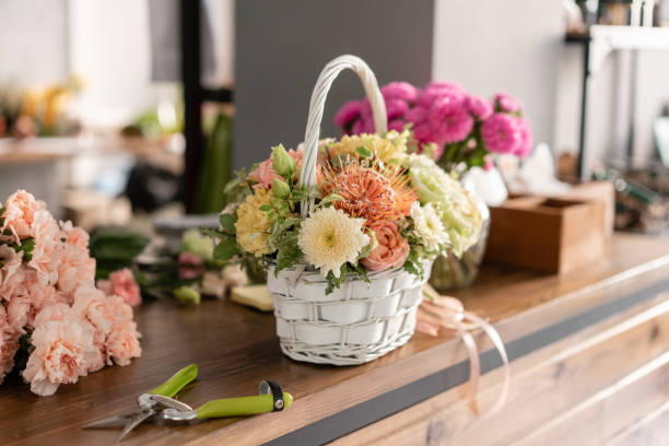 hermosa composición floral un ramo en una cesta de mimbre. concepto de floristería. colores de primavera - wicker basket store gift shop fotografías e imágenes de stock