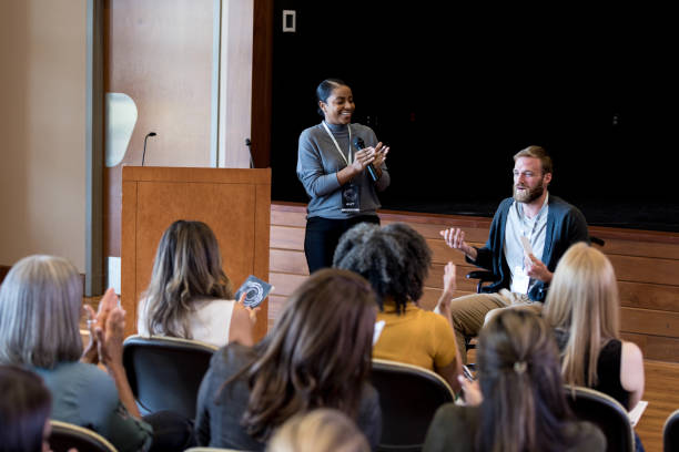 istock Unrecognizable audience applauds disabled hipster after speech 1178374695
