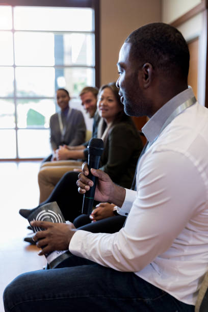 istock First panel speaker, a mid adult male addresses unseen audience 1178374700