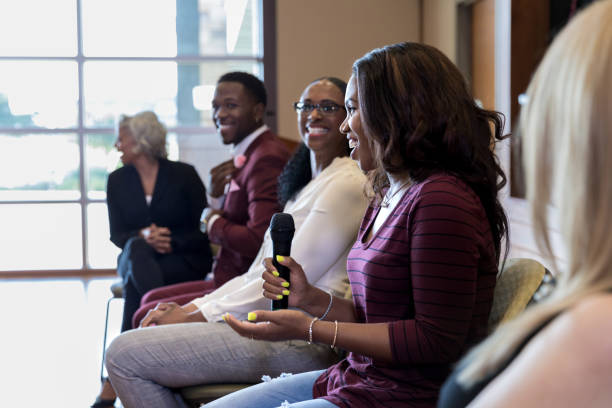 istock Mid adult woman's comments provoke laughter among panel members 1178374726