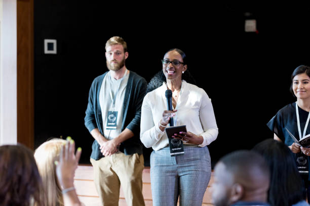istock Unrecognizable audience member raises hand, speaker answers question 1178374750