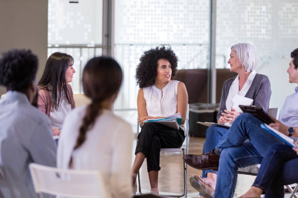 istock Young woman talks during community meeting 1178375575