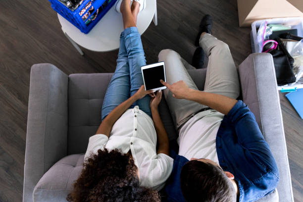 istock Young couple use tablet in new home 1178376614