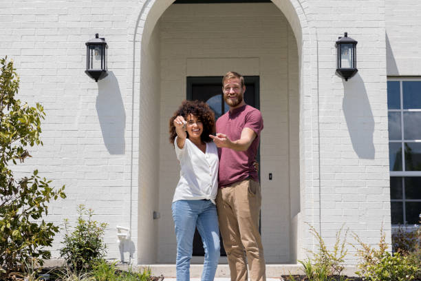 excited couple show off new home - garden key imagens e fotografias de stock