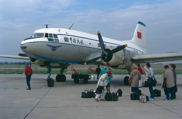 China (exact location unfortunately not known), 1978. Ilyushin IL-14 on a Chinese regional airfield. Also: passengers and travelers.