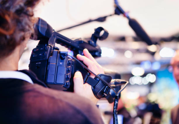 over shoulder shot closeup on a camera man