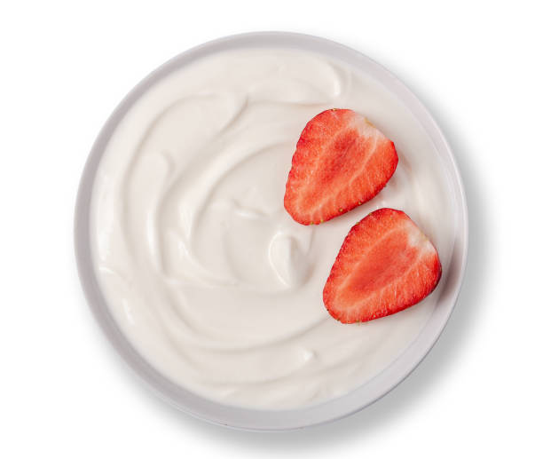 istock Yogurt in white bowl with strawberries and on the top on white background. 1178383745