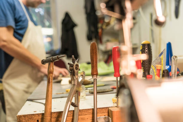 istock Shoemaker in shoe repair shop 1178385292