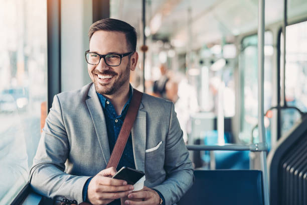istock Young businessman with a cell phone in a bus 1178385533