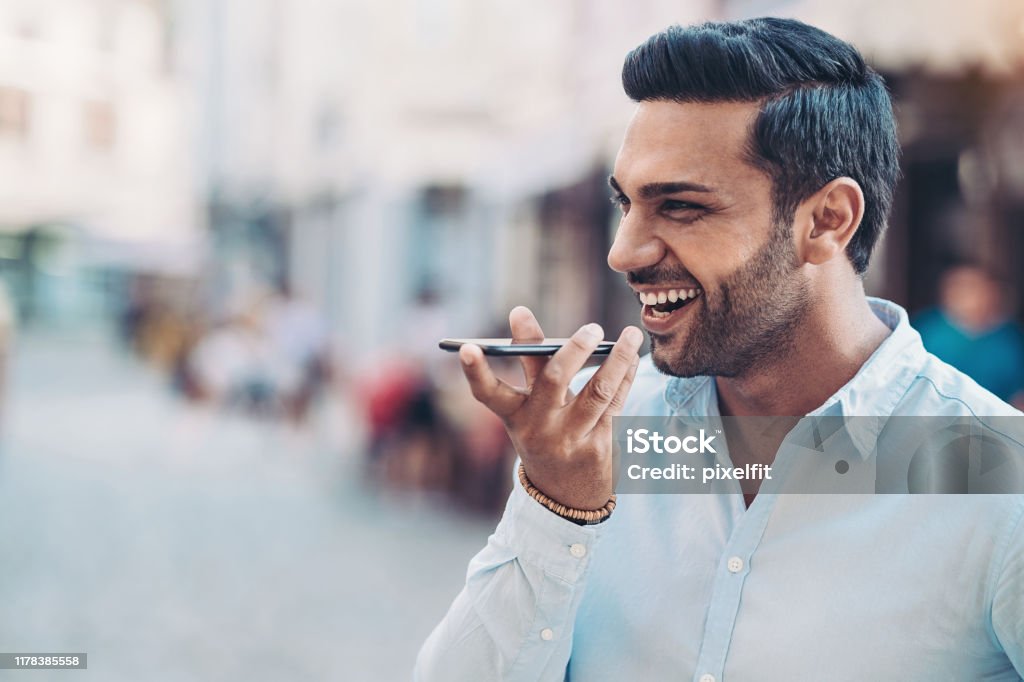 Voice recognition Businessman with a smart phone Talking Stock Photo