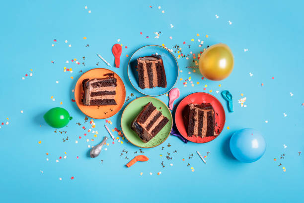 istock Chocolate cake slices on colorful plates and party decor 1178386765