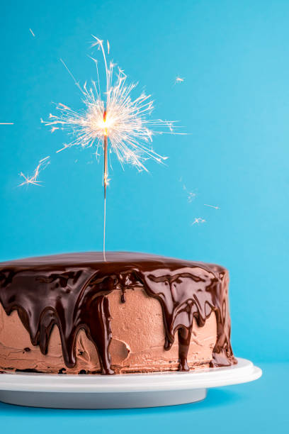 istock Chocolate glazed birthday cake with a sparkler. New year cake 1178386920