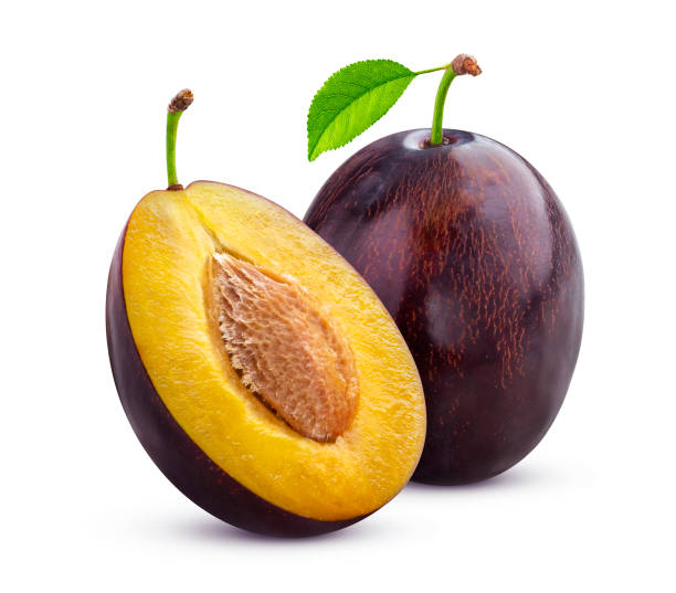 Plums with leaves isolated on white background