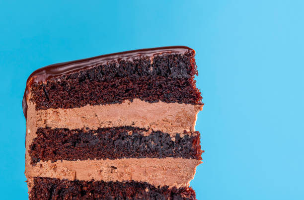istock Chocolate layered cake slice. Close-up on blue background 1178386978