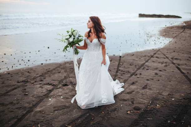 istock Bride on a beach in the blue water 1178389013