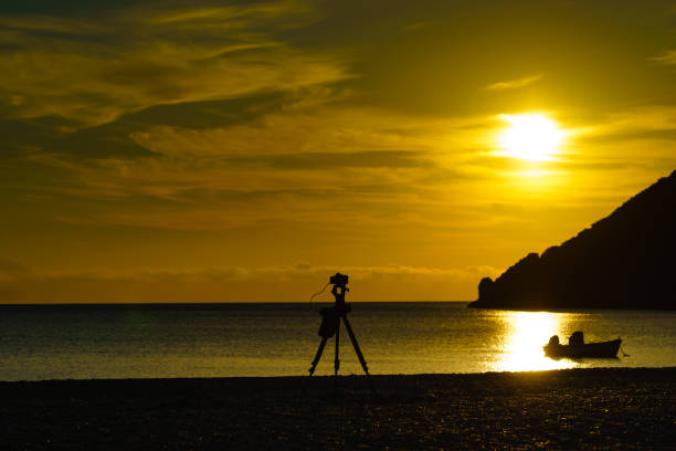 istock Camera taking picture of sunrise over sea surface 1178390624