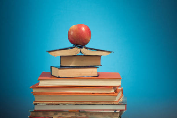 istock Book stack and apple on blue education background, back to school concept 1178390747