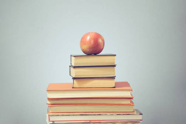 istock Book stack and apple on blue education background, back to school concept 1178390807