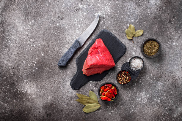 istock Raw meat on cutting board with spices 1178391135
