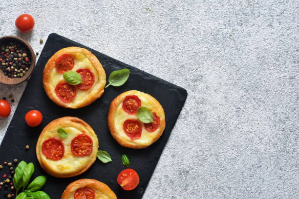 istock Mini pie with tomatoes and cheese. Quiche with vegetables and sauce top view. 1178392123
