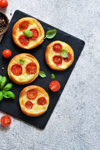 istock Mini pie with tomatoes and cheese. Quiche with vegetables and sauce top view. 1178392189