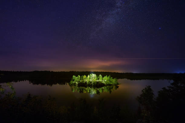 istock Mysterious illuminated island on the forest lake at night 1178392754