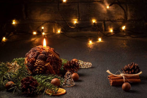 istock Christmas composition - decorative candle, Christmas tree branches and decorations on a dark background with blurry lights 1178393271