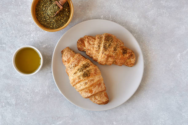 istock Croissant with zaatar on light stone table top view 1178393509