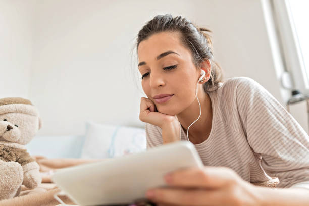 istock Beautiful woman using tablet in bedroom 1178394078