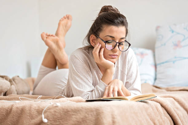 istock Woman reading book in bed 1178394292