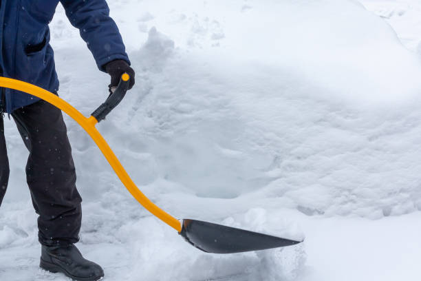 a man cleans snow in the yard with a shovel after a heavy snowfall - snow digging horizontal people imagens e fotografias de stock