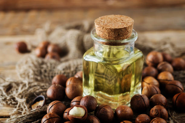 istock macadamia oil in glass with macadamia nuts 1178396244