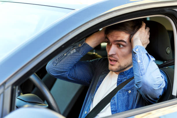 istock Annoyed man in car at traffic jam 1178397986