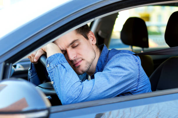 istock Tired man drives a car 1178398137