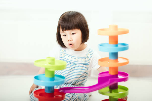 istock toddler girl play stack ball game at home 1178398380