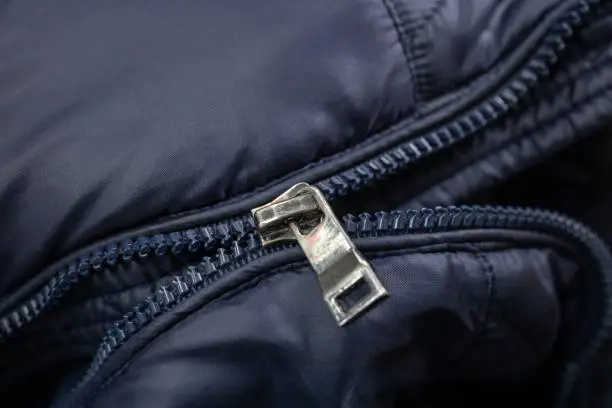 Photo of broken zipper lock. damaged zip closeup. fix cloth.