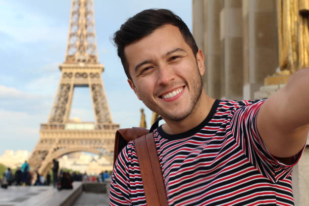 Cute tourist taking a selfie in France Cute tourist taking a selfie in France. exchange student stock pictures, royalty-free photos & images