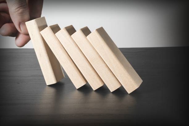 istock Hand stop falling wooden blocks. Domino effect. Risk protection concept 1178401444