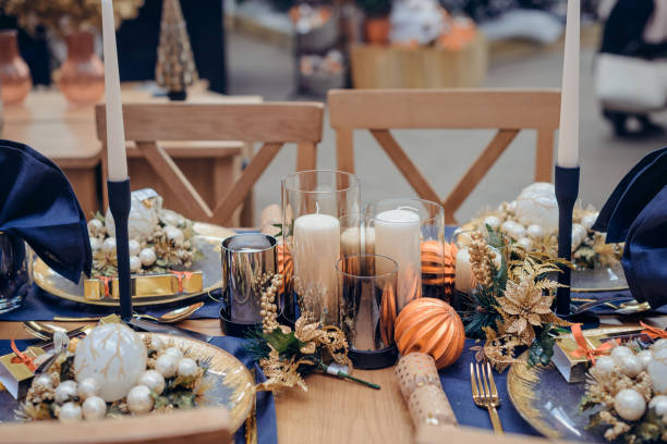 istock Christmastime table setting, festive dinnerware decorated with pretty details and candles in Blue and Gold colors. Navy Blue Table Linens and Gold Cutlery. Trends of Winter Holiday Tablescape Decor. 1178401759