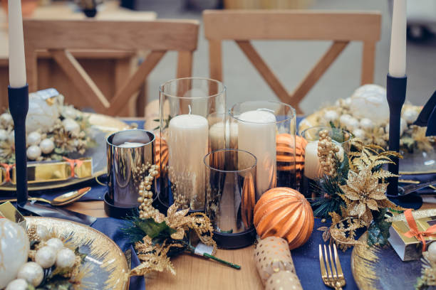 istock Christmastime table setting, festive dinnerware decorated with pretty details and candles in Blue and Gold colors. Navy Blue Table Linens and Gold Cutlery. Trends of Winter Holiday Tablescape Decor. 1178401767
